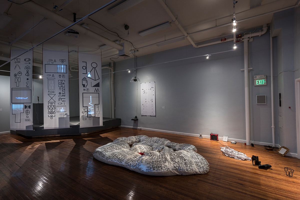 Wide installation view of Language Writes Myth Writes Reality at Maryland Art Place