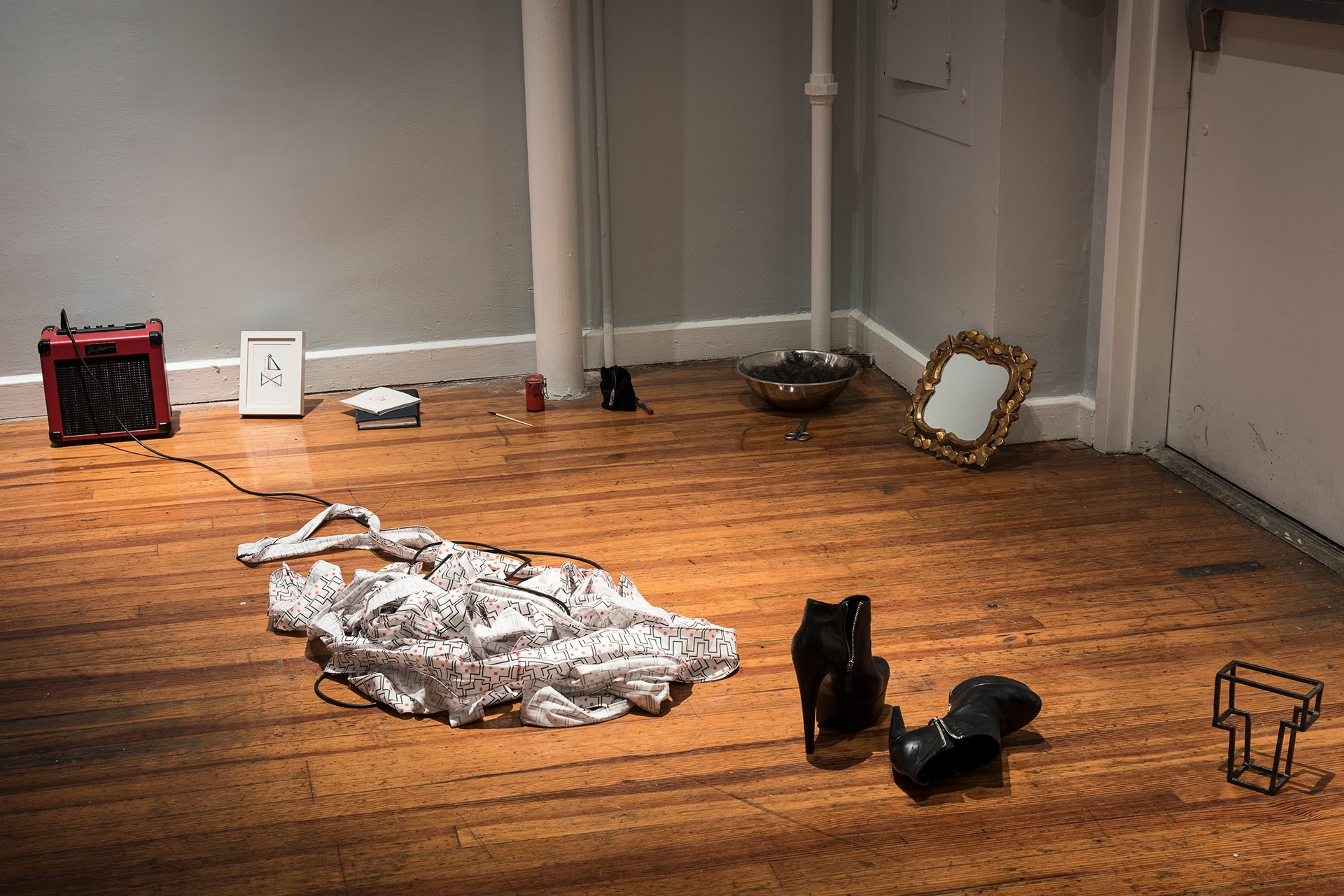 Objects from the performance arranged across the gallery floor