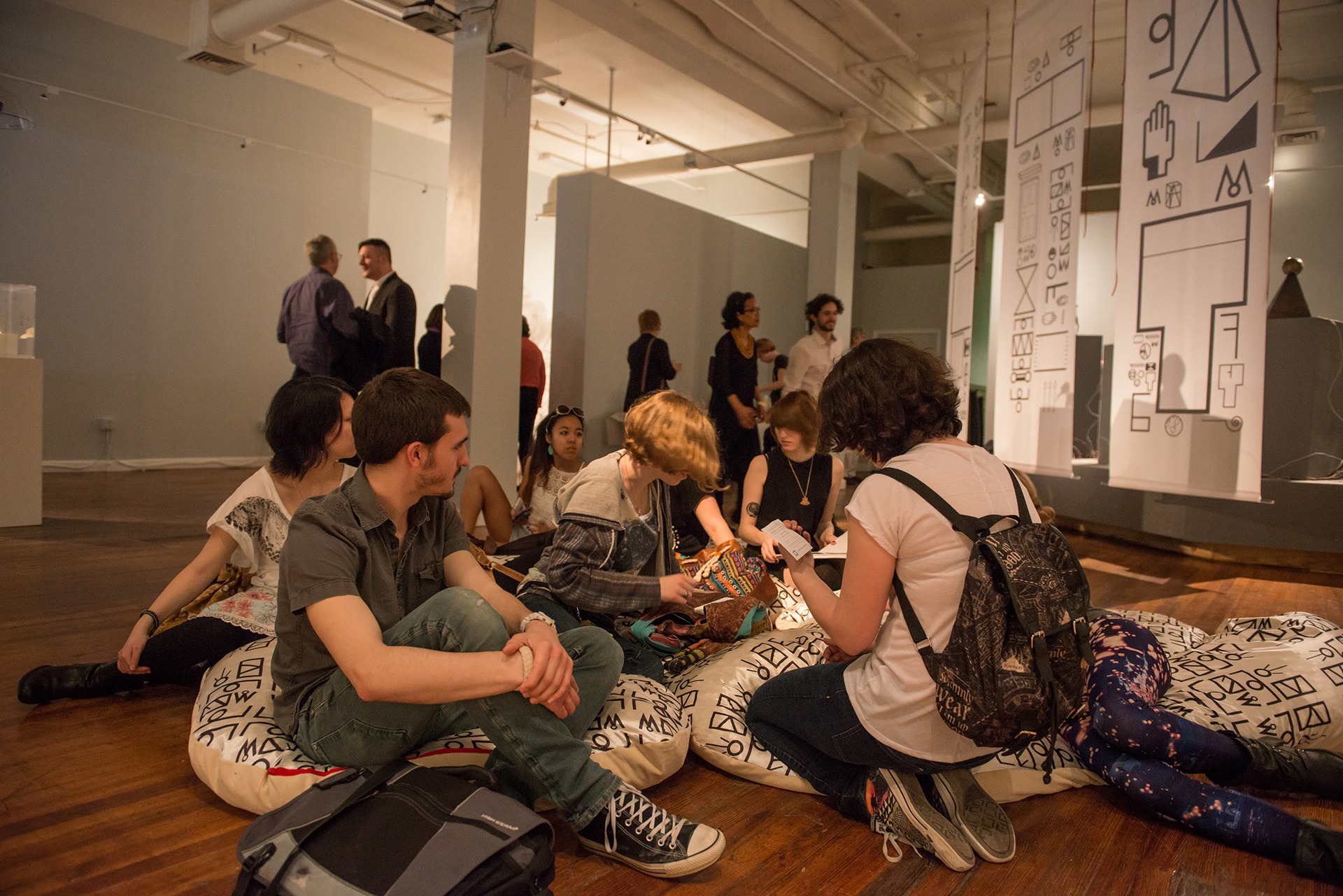 Visitors gathered within the Language Writes Myth Writes Reality installation