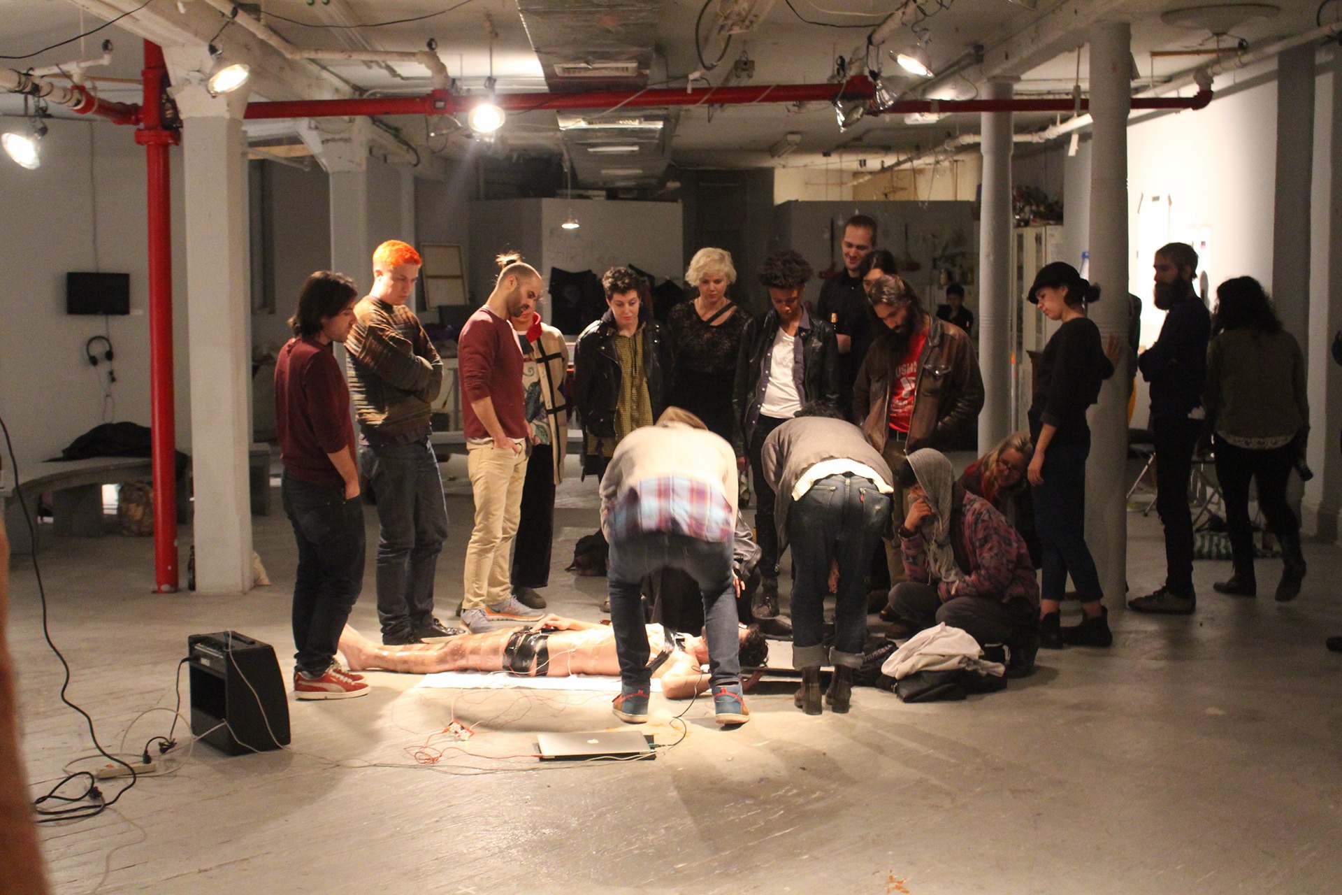 Audience gathered around Victor F. M. Torres during Please, Touch the Immigrant