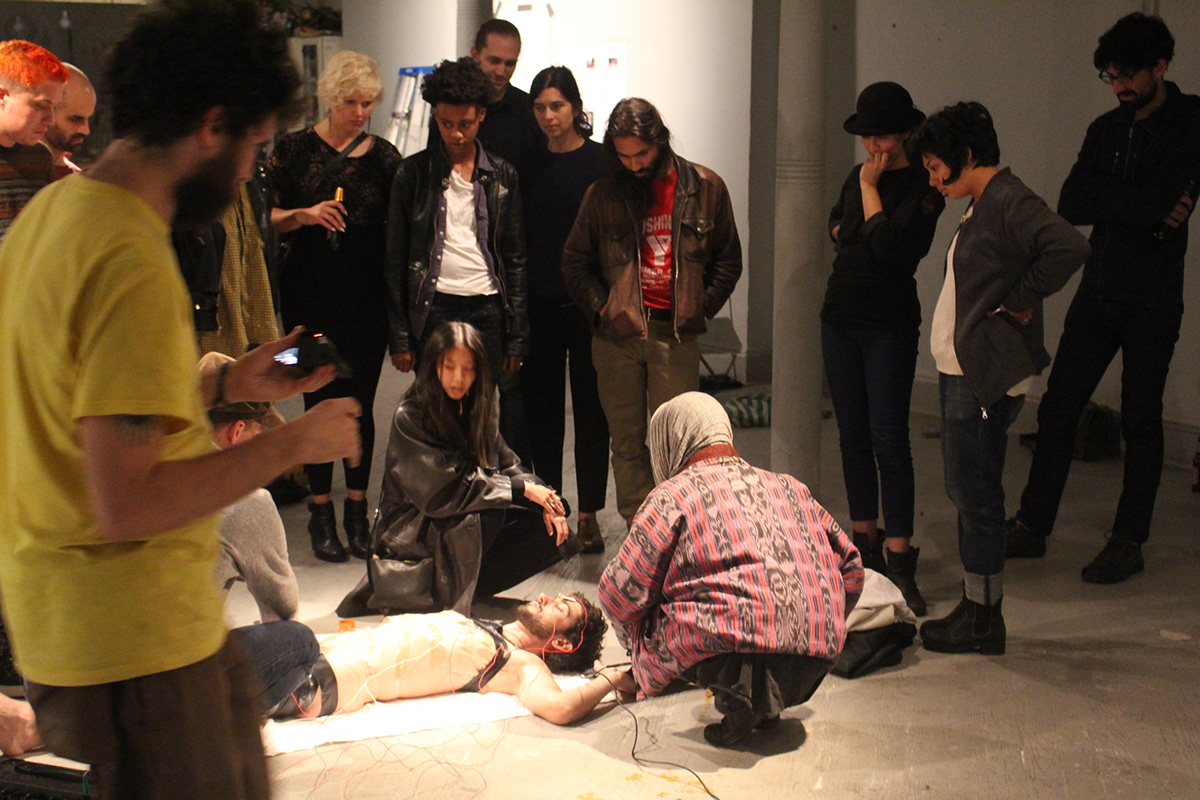 Audience members gathered closely around the artist during the performance
